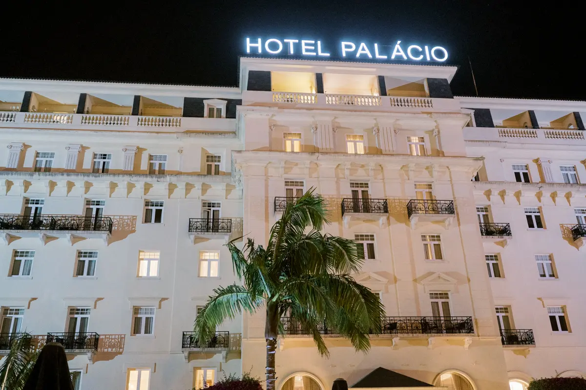 Facade of Palacio Estoril Hotel at night on a wedding day.
