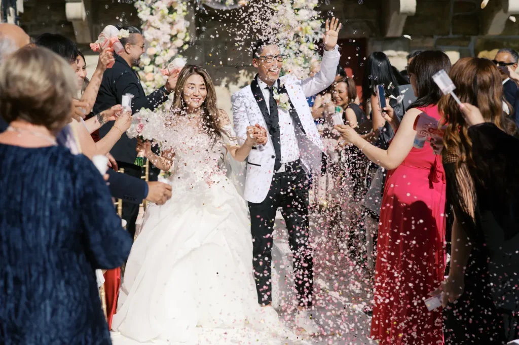 Saída dos noivos muito animada com chuva de confetis no Forte da Cruz, destination wedding Portugal.