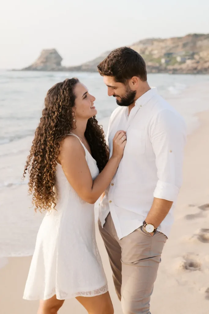 Casal de noivos a namorar na Praia do Porto Novo no Vimeiro, Torres Vedras, com luz de golden hour.